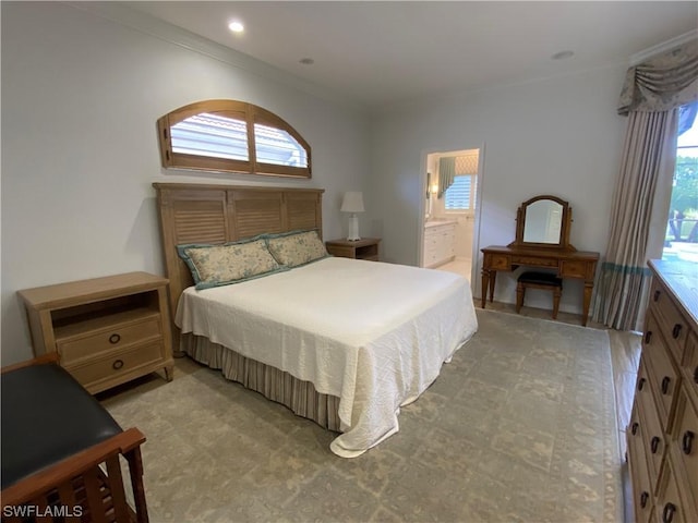 bedroom featuring crown molding and connected bathroom