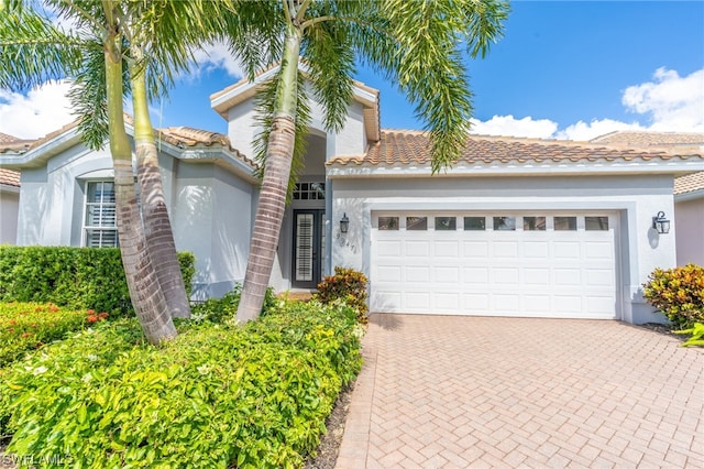 mediterranean / spanish-style house featuring a garage