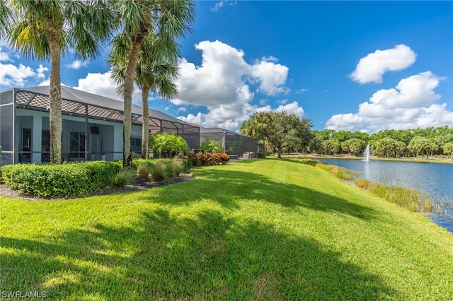 view of yard featuring a lanai and a water view