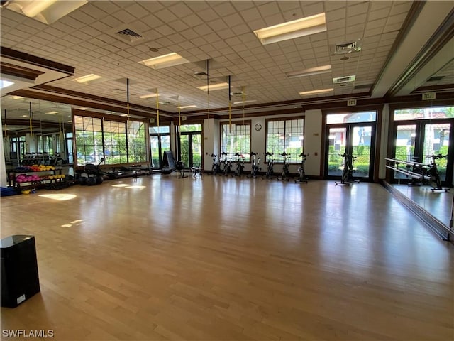 gym with hardwood / wood-style floors and french doors