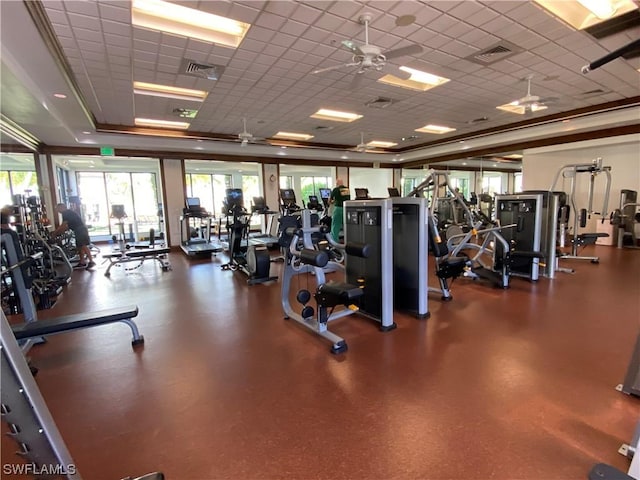 exercise room featuring a paneled ceiling and ceiling fan