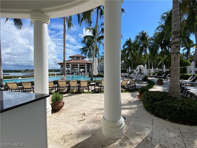 view of patio / terrace with a gazebo, a water view, and exterior bar