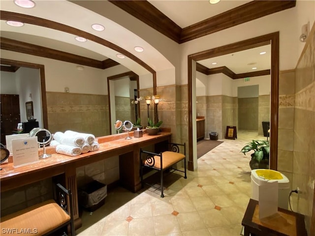 bathroom featuring tile walls, vanity, and crown molding