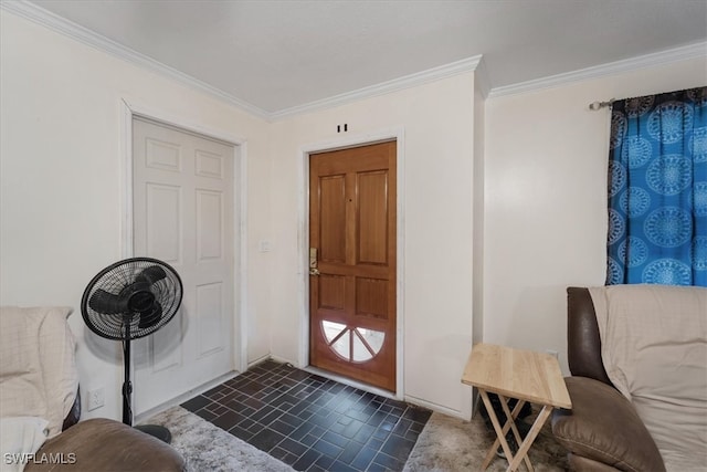 entrance foyer with dark tile patterned floors and crown molding