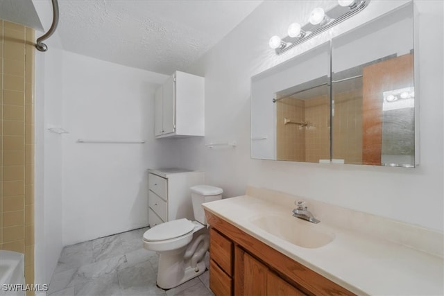 bathroom featuring vanity, a textured ceiling, and toilet