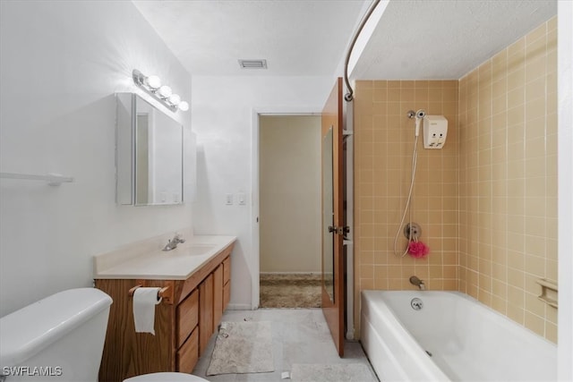 full bathroom with tile patterned flooring, vanity, toilet, and tiled shower / bath