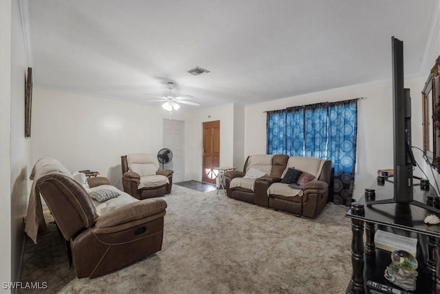 living room featuring ceiling fan, crown molding, and carpet floors