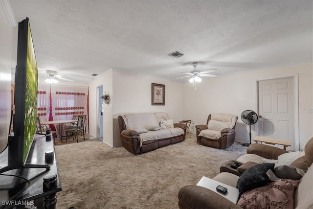 carpeted living room featuring ceiling fan, crown molding, and a textured ceiling