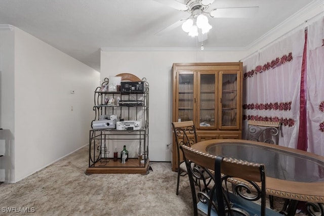 dining room with carpet flooring, ceiling fan, and ornamental molding