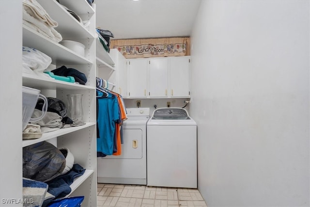 clothes washing area featuring cabinets and separate washer and dryer