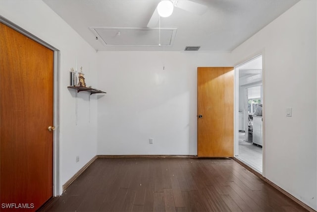 unfurnished room featuring ceiling fan and dark wood-type flooring