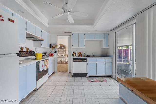 kitchen featuring white appliances, a raised ceiling, ceiling fan, sink, and white cabinets