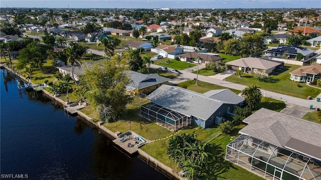 drone / aerial view with a residential view and a water view