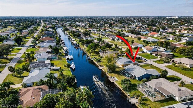 birds eye view of property with a water view and a residential view