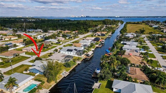 drone / aerial view featuring a water view and a residential view