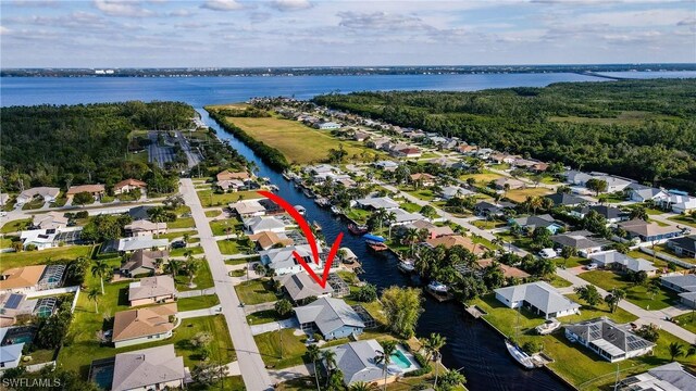 drone / aerial view with a water view and a residential view