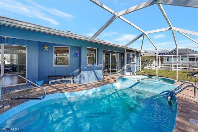 outdoor pool with a lanai, a patio area, and a jacuzzi