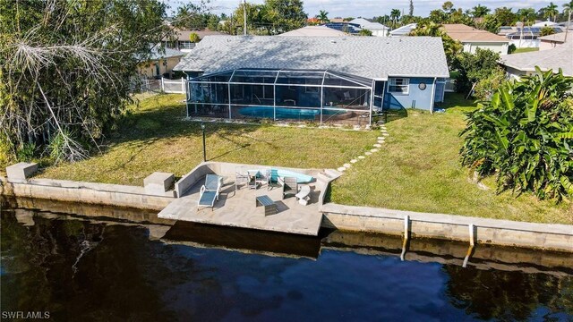 dock area with a lanai, a water view, a lawn, an outdoor pool, and a patio area