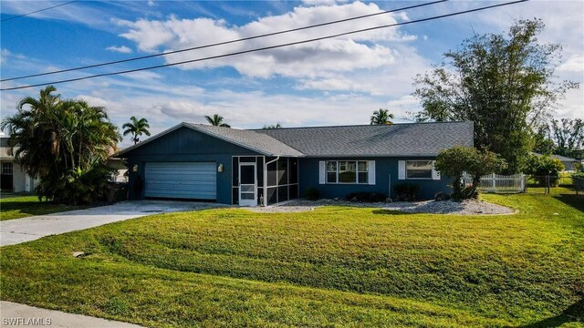 single story home with a front yard, concrete driveway, fence, and an attached garage