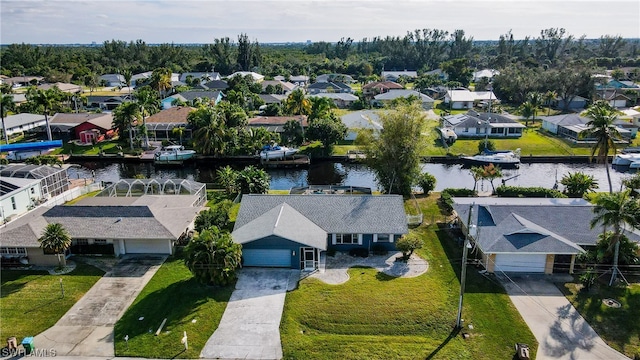 drone / aerial view featuring a residential view and a water view