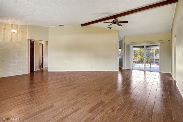 unfurnished living room with vaulted ceiling with beams, visible vents, ceiling fan, a textured ceiling, and wood finished floors