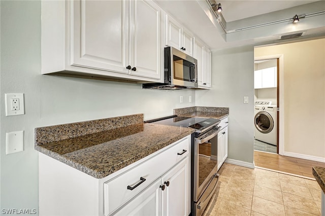 kitchen featuring light tile patterned floors, visible vents, white cabinets, baseboards, and appliances with stainless steel finishes