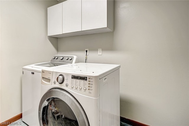 laundry area featuring cabinet space, baseboards, and independent washer and dryer