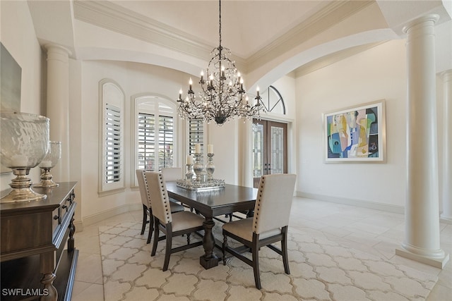 tiled dining room featuring crown molding, a chandelier, and decorative columns