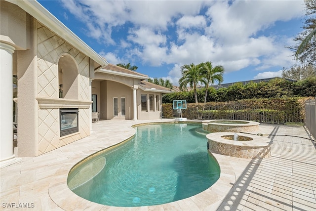 view of swimming pool with a patio area and an in ground hot tub