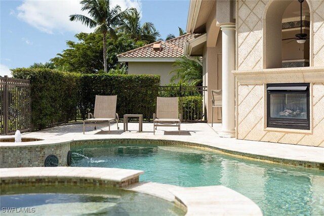 view of pool with a patio and ceiling fan