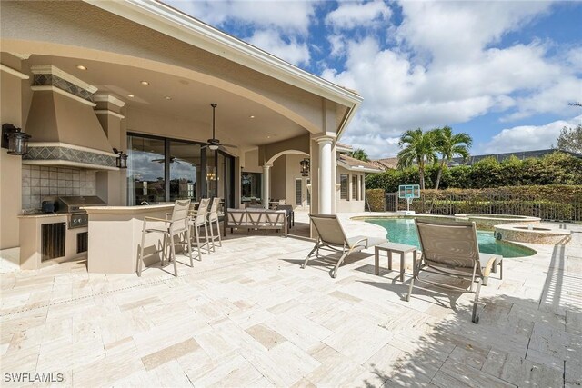 view of patio featuring ceiling fan, area for grilling, exterior bar, a fenced in pool, and a grill