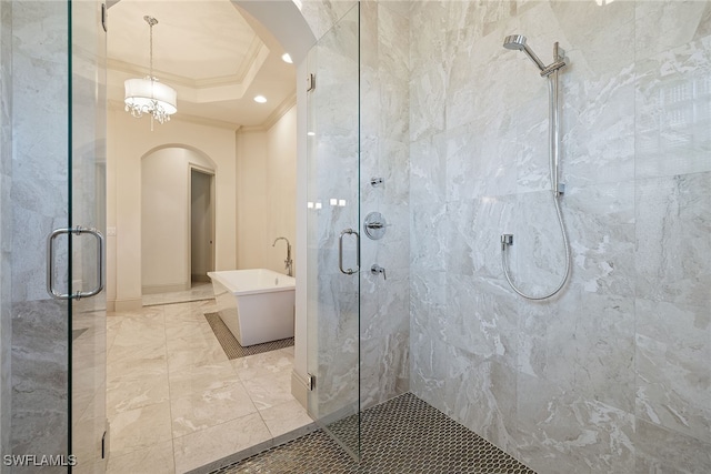 bathroom with crown molding, shower with separate bathtub, a notable chandelier, and a tray ceiling