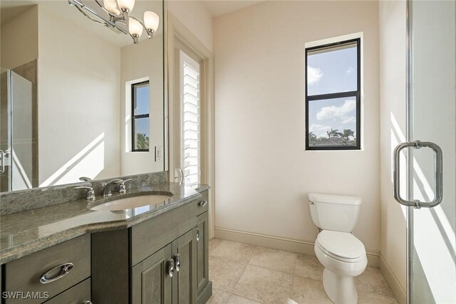 bathroom featuring vanity, a chandelier, and toilet