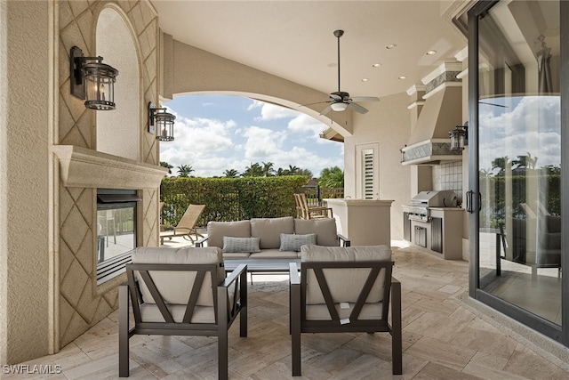 view of patio featuring exterior kitchen, an outdoor living space, a grill, and ceiling fan