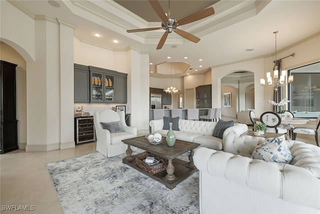 living room featuring a tray ceiling, ornamental molding, and light tile patterned flooring