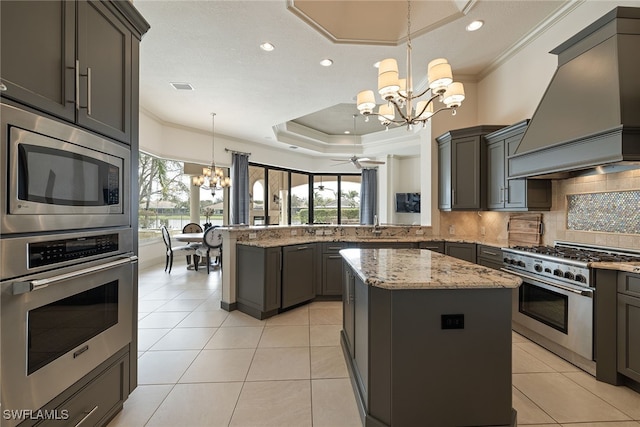 kitchen featuring custom exhaust hood, kitchen peninsula, a kitchen island, pendant lighting, and stainless steel appliances