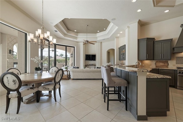16540 Cellini Ln, Naples, FL 34110 - dining room with crown molding, light tile patterned floors, ceiling fan with notable chandelier, and arched walkways