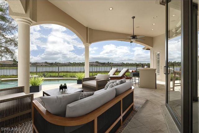 16540 Cellini Ln, Naples, FL 34110 - view of patio with an outdoor living space, a water view, a ceiling fan, and fence