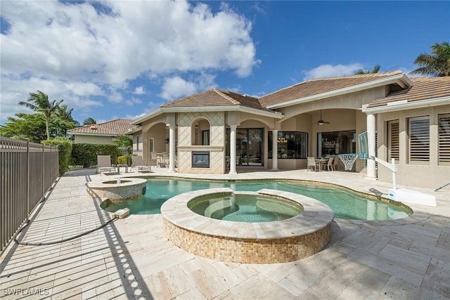 16540 Cellini Ln, Naples, FL 34110 - rear view of property featuring a pool with connected hot tub, stucco siding, ceiling fan, a fenced backyard, and a patio area