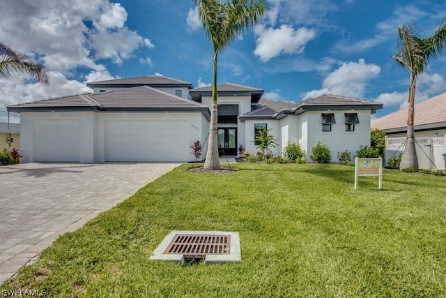 view of front of property featuring a front lawn and a garage