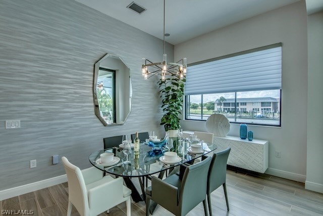 dining space featuring a chandelier and hardwood / wood-style floors