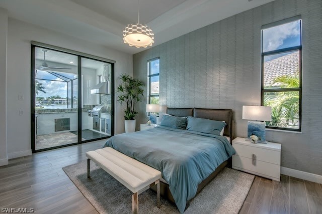 bedroom featuring light hardwood / wood-style flooring and multiple windows