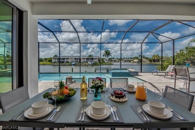 exterior space with a water view, a lanai, and a patio area