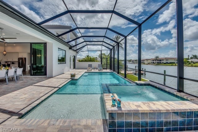 view of swimming pool featuring a lanai, a water view, ceiling fan, and a patio area