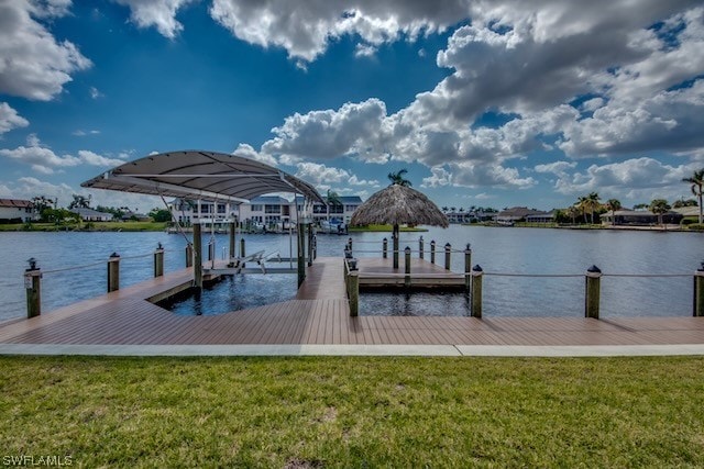 dock area with a water view and a yard