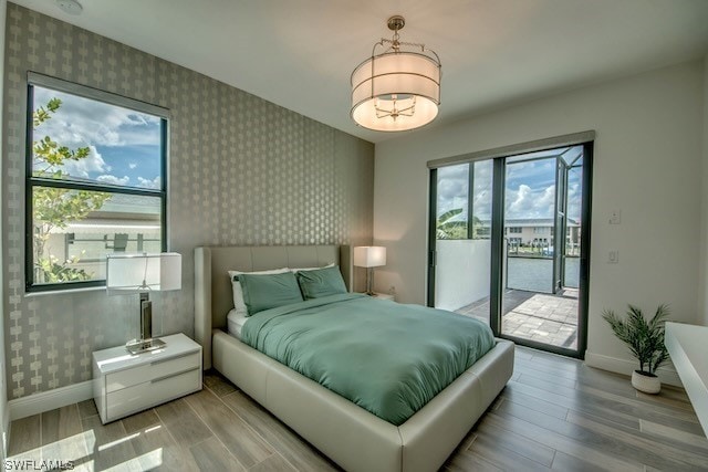 bedroom featuring light hardwood / wood-style flooring and access to exterior