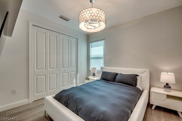 bedroom with light wood-type flooring and a closet