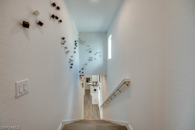 stairs featuring hardwood / wood-style floors