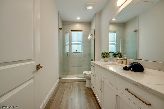 bathroom featuring wood-type flooring, vanity, toilet, and an enclosed shower