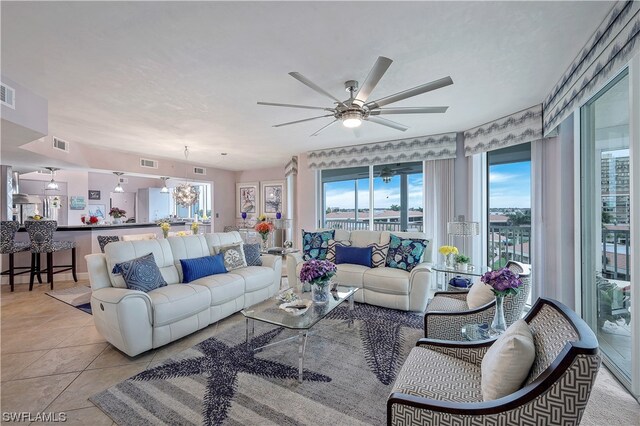 living room with light tile floors and ceiling fan